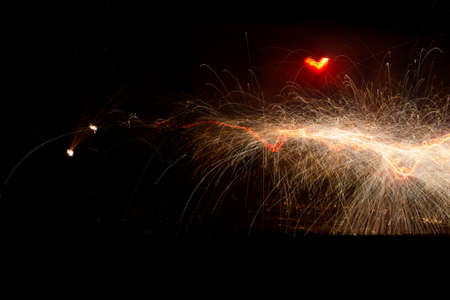 large line of yellow electricity sparks and upper red lightの写真素材