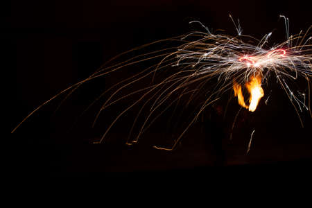 sparks of metallurgy with a flame of fire on the right