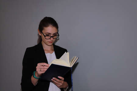 work break - young business woman resting and reading a bookの写真素材