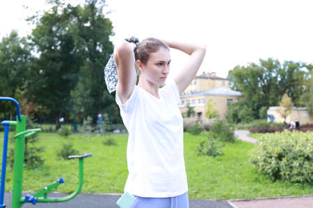 let's keep fit - young girl exercising outdoorsの写真素材