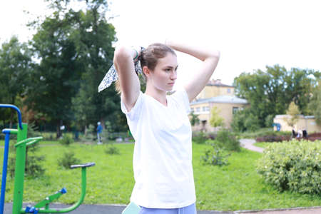 let's keep fit - young girl exercising outdoorsの写真素材