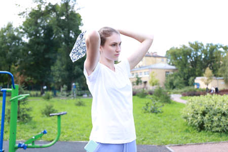 let's keep fit - young girl exercising outdoorsの写真素材