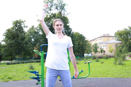 let's keep fit - young girl exercising outdoorsの写真素材