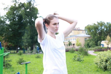 let's keep fit - young girl exercising outdoorsの写真素材