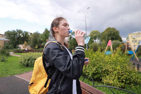 let's keep fit! sports walking with a young girl outdoorsの写真素材
