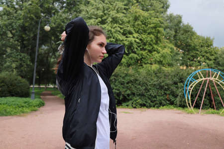 let's keep fit! sports walking with a young girl outdoorsの写真素材