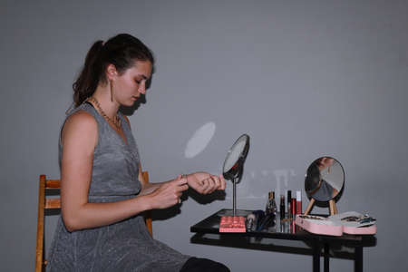 behind the scenes of going on a date - young girl is doing her makeupの写真素材