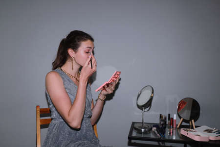 behind the scenes of going on a date - young girl is doing her makeupの写真素材