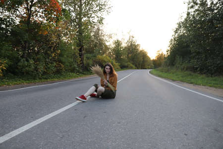 young girl on the lonely road on the countryside