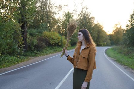 young girl on the lonely road on the countryside
