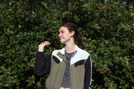portrait of a cute girl on a background of trees