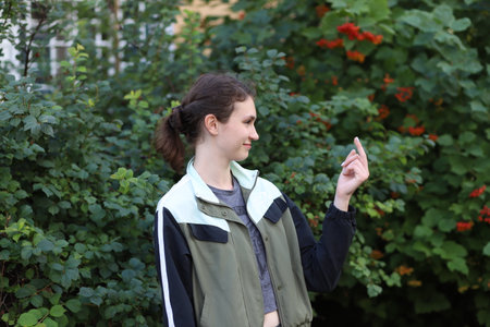 portrait of a cute girl on a background of treesの写真素材