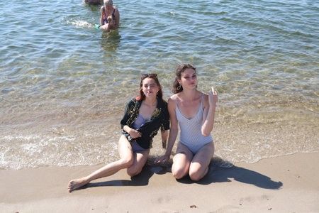 group of friends having fun on the sea beachの写真素材
