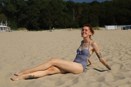 golden sand and a young girl in a bathing suitの写真素材