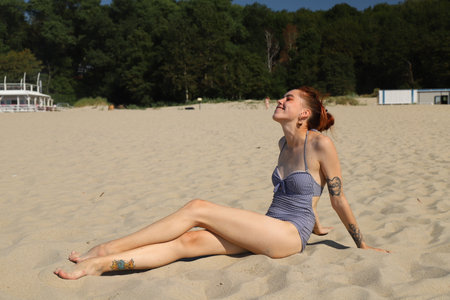 golden sand and a young girl in a bathing suitの写真素材