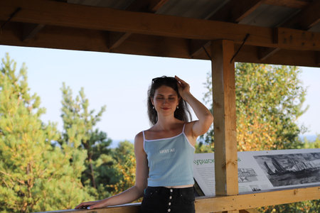 portrait of a young woman on a background of treesの写真素材