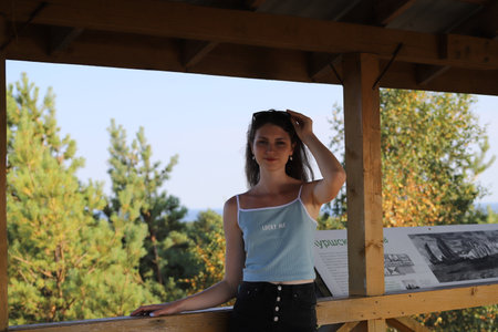 portrait of a young woman on a background of treesの写真素材