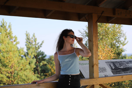 portrait of a young woman on a background of treesの写真素材
