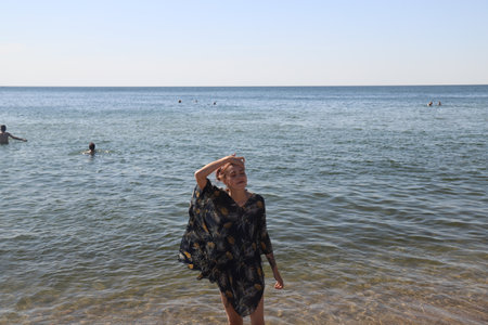 girl in swimsuit walking on the beachの写真素材