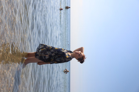 girl in swimsuit walking on the beachの写真素材