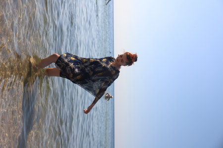 girl in swimsuit walking on the beachの写真素材