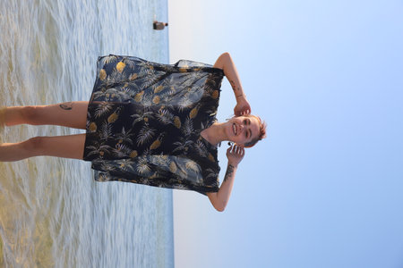girl in swimsuit walking on the beachの写真素材