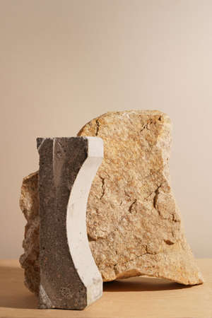 Beige stone and a piece of gray podium tile on a beige background, natural background for your productの写真素材