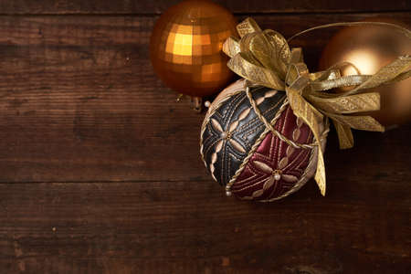 Beautiful Golden Christmas balloons, luxury decoration on wooden old brown backgroundの写真素材