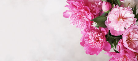 Bouquet of pink peonies on a beige picturesque banner with a copy space. High quality photoの写真素材