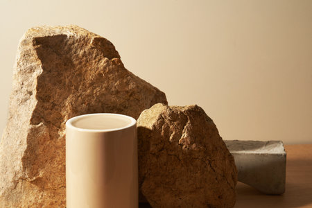 Beige stone and a piece of gray podium tile on a beige background, natural background for your...