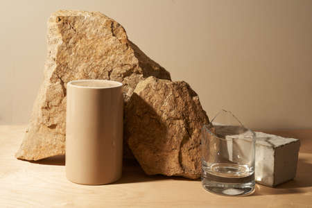 Beige stone, a piece of gray podium tile and broken glass on a beige background, natural background for your productの写真素材