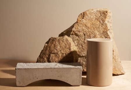 Beige stone and a piece of gray podium tile on a beige background, natural background for your productの写真素材