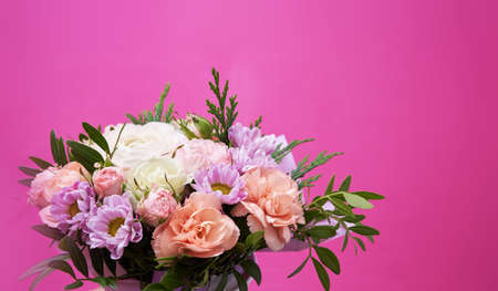 Beautiful bouquet of mixed different flowers on pink background, greeting, giftの写真素材