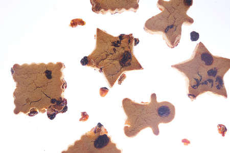 Cookies in different shapes, gluten-free, lactose-free, healthy dessert with dark chocolate and raisins on an isolated white background, levitationの写真素材