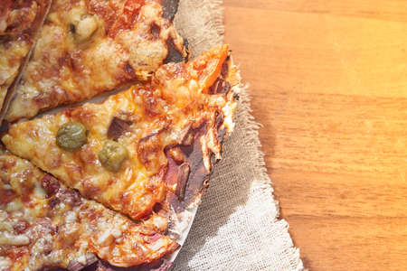 Healthy gluten-free pizza with beef. Gluten-free cooking class. Cooking at home. Pizza on a linen napkin on a wooden background.の写真素材