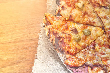 Healthy gluten-free pizza with beef. Gluten-free cooking class. Cooking at home. Pizza on a linen napkin on a wooden background.の写真素材