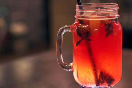 Christmas drink red non-alcoholic mulled wine with a straw on the background of the cafe interior, order for oneの写真素材