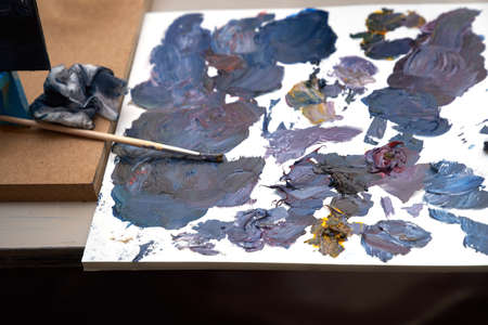 A palette with multi-colored paint and brushes for drawing. High quality photoの写真素材