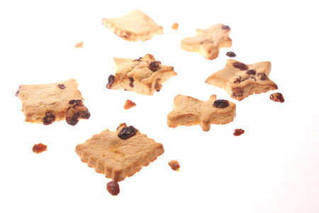 Cookies in different shapes, gluten-free, lactose-free, healthy dessert with dark chocolate and raisins on an isolated white background, levitationの写真素材
