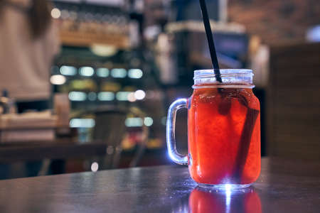 Christmas drink red non-alcoholic mulled wine with a straw on the background of the cafe interior, order for oneの写真素材