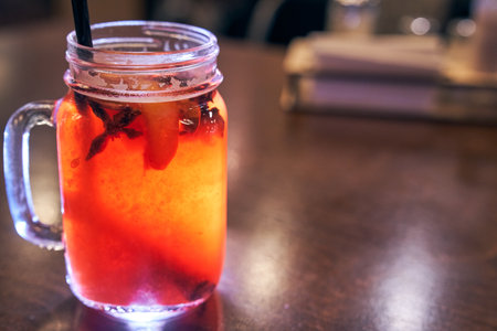 Christmas drink red non-alcoholic mulled wine with a straw on the background of the cafe interior, order for oneの写真素材