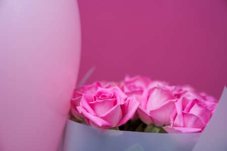 A beautiful bouquet of pink roses on a pink background, natural flowers, banner with copy space. High quality photoの写真素材