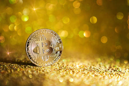 One Bitcoin coin. The bitcoin cryptocurrency is the coin of the future. Golden Bitcoin. Golden shiny...