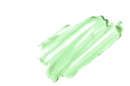The smear and texture of the cream.Pistachio color, isolated on a white background. An element for...