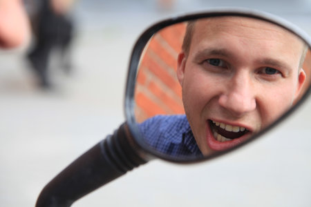 Portrait of a man in a mirror image.A comical, cheerful, cheerful guy in the mirror from a...
