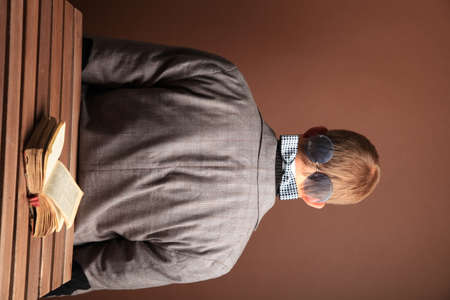 Portrait of a man.A comical, cheerful, cheerful guy in a suit is sitting with his back to the...