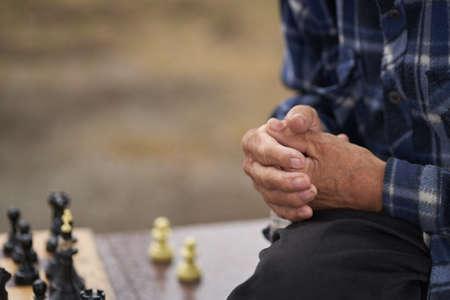 The hands of one of the men playing chess. Chess board game concept of business ideas and competition and strategic plan the meaning of success. High quality photoの写真素材