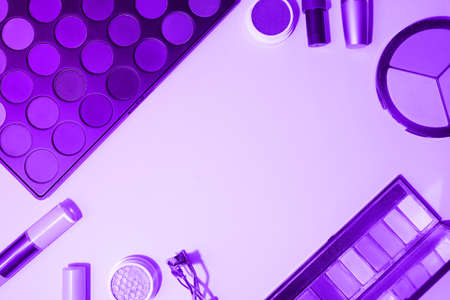 Decorative cosmetics, top view. Make-up with professional cosmetics, in lilac color. A flat image with space to copy. High quality photoの写真素材