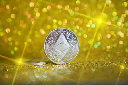 The reverse side is ether. Cryptocurrency ether is the coin of the future. Golden ether. Golden shiny background. High quality photoの写真素材