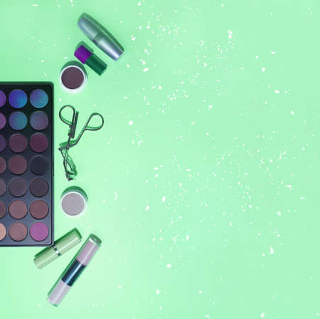 Decorative cosmetics, top view. Make-up with professional cosmetics, on a green background.の写真素材